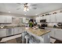 Bright kitchen with granite countertops, island, stainless steel appliances, and white cabinets at 424 W Midland Ln, Gilbert, AZ 85233