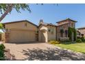 Lovely home with a three-car garage, stone accents, well-manicured lawn, and a paver driveway at 5226 S Fairchild Ln, Chandler, AZ 85249