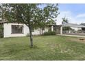 Well-manicured lawn and mature tree compliment this home's charming curb appeal at 549 N Olive --, Mesa, AZ 85203