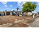 Inviting home featuring a large driveway and convenient garage access at 5519 W Campbell Ave, Phoenix, AZ 85031