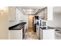 Cozy kitchen features white cabinets, stainless steel appliances, and tiled floors at 5809 E Thomas Rd, Scottsdale, AZ 85251