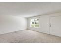Comfortable living room with a front door and a window providing natural light at 5809 E Thomas Rd, Scottsdale, AZ 85251