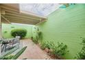 Beautiful backyard with brick pavers, desert landscaping, plants and green accent wall at 6626 N Majorca E Way, Phoenix, AZ 85016