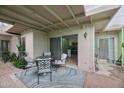 Inviting covered patio with furniture set on brick pavers, perfect for outdoor dining and relaxation at 6626 N Majorca E Way, Phoenix, AZ 85016