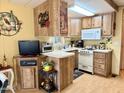 Efficient kitchen layout with white appliances and ample cabinetry for storage and functionality at 7750 E Broadway Rd # 123, Mesa, AZ 85208