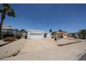 Single-story home featuring a two-car garage and low-maintenance desert landscaping at 812 E Piute Ave, Phoenix, AZ 85024