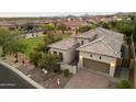 Aerial view of home featuring a three-car garage and desert landscaping at 8234 E Inca St, Mesa, AZ 85207