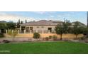 Well maintained backyard with turf, desert landscaping, and rod iron fence at 8234 E Inca St, Mesa, AZ 85207