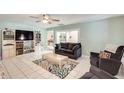 Comfortable living room with tiled flooring, a ceiling fan, and natural light at 8907 N 85Th Way, Scottsdale, AZ 85258