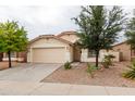 Charming single-story home with a two-car garage and low maintenance desert landscaping at 9319 W Crown King Rd, Tolleson, AZ 85353