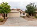 Charming single-story home with a two-car garage, desert landscaping, and neutral paint at 9319 W Crown King Rd, Tolleson, AZ 85353
