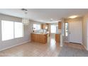 Bright kitchen area with tiled flooring, pendant lighting, and a pass through counter at 9319 W Crown King Rd, Tolleson, AZ 85353
