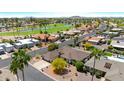 Expansive aerial view of a residential neighborhood with lush green golf course at 9621 E Calgary Ave, Sun Lakes, AZ 85248