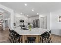 Bright kitchen featuring a large center island with bar seating and stainless steel appliances at 108 E Horseshoe Ave, Gilbert, AZ 85296