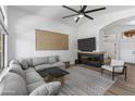 Cozy living room with a modern fireplace, large windows, and comfortable seating arrangement at 108 E Horseshoe Ave, Gilbert, AZ 85296
