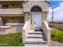 Welcoming front entrance featuring white door, stone steps, and an arched entryway at 1333 E Morten Ave # 230, Phoenix, AZ 85020