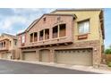 Attractive home exterior displaying a multi-car garage, upper balconies, and a well-maintained facade at 1350 S Greenfield Rd # 1125, Mesa, AZ 85206