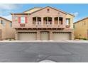 Inviting exterior view of a multi-story home featuring three garage doors and charming balconies at 1350 S Greenfield Rd # 1125, Mesa, AZ 85206
