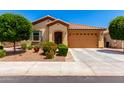 Inviting single-story home showcasing a landscaped front yard and a spacious two-car garage at 1361 N Claiborne --, Mesa, AZ 85205