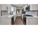 Bright kitchen with white cabinets, stainless steel appliances, and stylish backsplash at 1529 E Edgemont Ave, Phoenix, AZ 85006