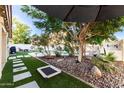 Lush backyard with an inviting pool, artificial grass, and mature landscaping at 15829 S 13Th Pl, Phoenix, AZ 85048