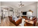 Bright living room with vaulted ceilings, hardwood floors, and comfortable leather seating, creating an inviting space at 16055 S 18Th Dr, Phoenix, AZ 85045