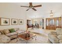 Bright and airy living room featuring tile floors, a ceiling fan, and an open view to the dining area at 17030 N 57Th St, Scottsdale, AZ 85254