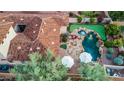 Overhead view of the backyard with a lovely pool, integrated spa, and putting green, complete with seating at 18500 N 95Th St, Scottsdale, AZ 85255