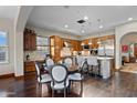 Spacious kitchen with a large island, stainless appliances, and a breakfast area with a round wooden table at 18500 N 95Th St, Scottsdale, AZ 85255