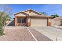 Charming single-story home with desert landscaping, covered porch, and a two-car garage at 21181 N 80Th Ln, Peoria, AZ 85382