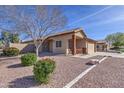 Single-story home with desert landscaping, security doors, covered porch, and a two-car garage at 21181 N 80Th Ln, Peoria, AZ 85382