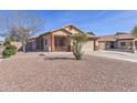 Single-story home featuring a low-maintenance desert landscape, covered porch, and a two-car garage at 21181 N 80Th Ln, Peoria, AZ 85382
