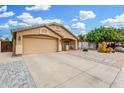 Well-maintained single-story home featuring a two-car garage, neutral exterior, and desert landscaping at 2300 E Austin Dr, Gilbert, AZ 85296