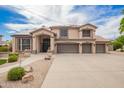 Charming two-story home with a three-car garage, covered entry, tile roof, and desert landscaping at 24916 N 80Th Ln, Peoria, AZ 85383