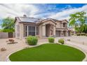 Lovely two-story home with a three-car garage, covered entry, tile roof, solar panels and desert landscaping at 24916 N 80Th Ln, Peoria, AZ 85383