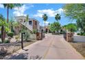 Beautiful two-story house boasting a gated entrance, lush landscaping, and a well-maintained driveway at 2527 E Beechnut Ct, Chandler, AZ 85249