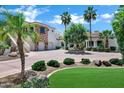 Gorgeous home with a circular driveway, manicured lawn, and an attached three-car garage at 2527 E Beechnut Ct, Chandler, AZ 85249