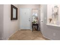 Clean tiled entryway with neutral walls leads into a well-lit area near a front door and window at 2685 N 132Nd Dr, Goodyear, AZ 85395