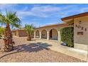 Inviting home featuring a charming, covered entry way, desert landscaping, and well-kept bushes at 3021 S Evergreen Rd, Tempe, AZ 85282