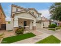 Charming two-story home featuring a covered porch, a two car garage and a landscaped front yard at 3308 E Jasper Dr, Gilbert, AZ 85296