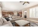 Open concept living space with a large sectional sofa and view to the dining and kitchen areas at 3308 E Jasper Dr, Gilbert, AZ 85296