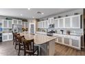 Well-equipped kitchen with a large granite island, stainless steel appliances, and ample cabinet space at 3515 N Brooklyn Dr, Buckeye, AZ 85396