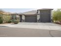 Beautiful exterior featuring a three-car garage, neutral tones, and well-maintained landscaping at 3911 S 78Th Ln, Phoenix, AZ 85043