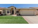 Charming single-story home featuring a well-manicured lawn and an attached two-car garage at 4117 W Whispering Wind Dr, Glendale, AZ 85310