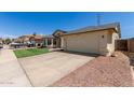 Charming single-story home featuring an attached two-car garage and desert landscaping at 4117 W Whispering Wind Dr, Glendale, AZ 85310