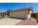 Charming single-story home featuring an attached two-car garage and desert landscaping at 4117 W Whispering Wind Dr, Glendale, AZ 85310