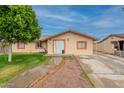 Inviting home featuring a manicured lawn, walkway, and colorful exterior trim at 4160 W Granada Rd, Phoenix, AZ 85009