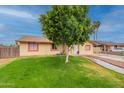 Attractive house featuring green lawn, mature trees, and side parking at 4160 W Granada Rd, Phoenix, AZ 85009