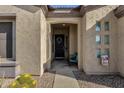 Inviting front porch with decorative wreath, a cozy sitting area, and desert-friendly landscaping at 4293 E Sourwood Dr, Gilbert, AZ 85298