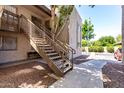 Apartment staircase with well maintained landscaping and neutral color scheme at 520 N Stapley Dr # 253, Mesa, AZ 85203